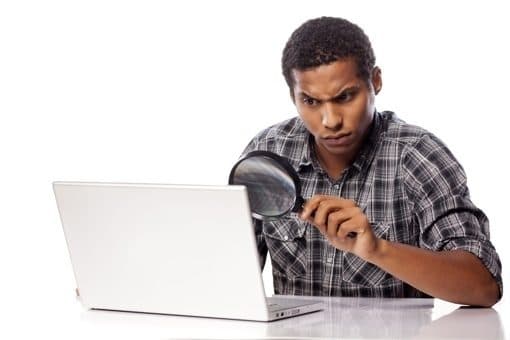 Man at computer with magnifying glass shutterstock 510px