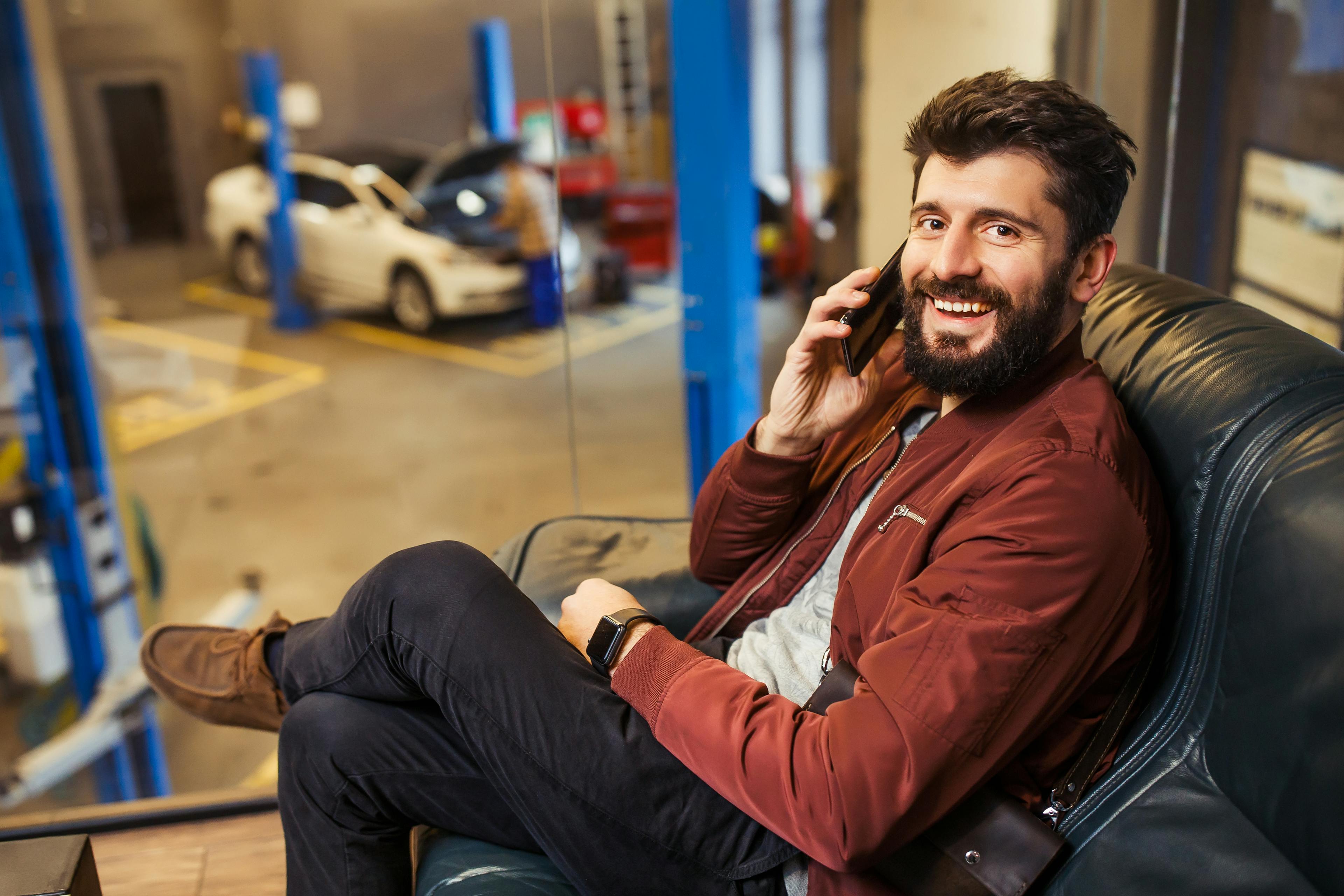 https://wsa-website-assets.s3.amazonaws.com/assets/images/cheerful-bearded-man-sitting-waiting-room-car-service-center-talking-smartphone-looking-camera.jpg