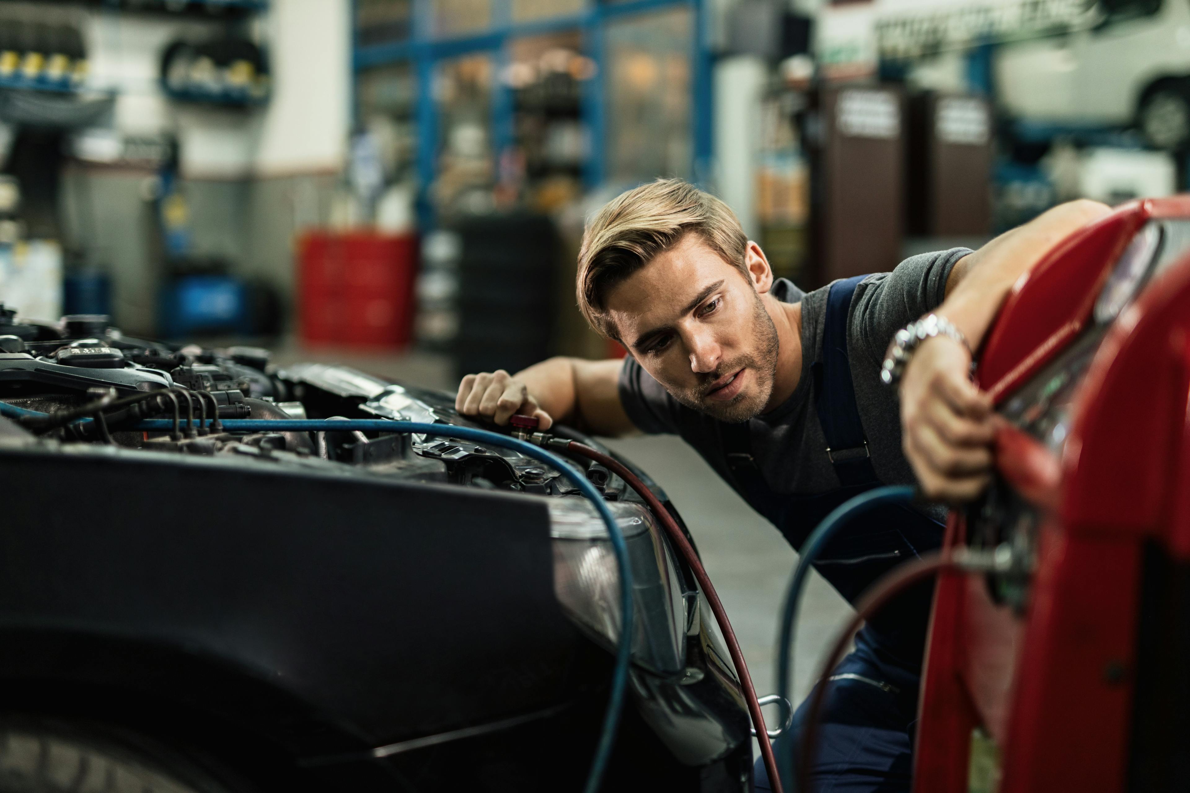 https://wsa-website-assets.s3.amazonaws.com/assets/images/young-auto-mechanic-using-compressor-while-maintaining-ac-unit-car-workshop.jpg